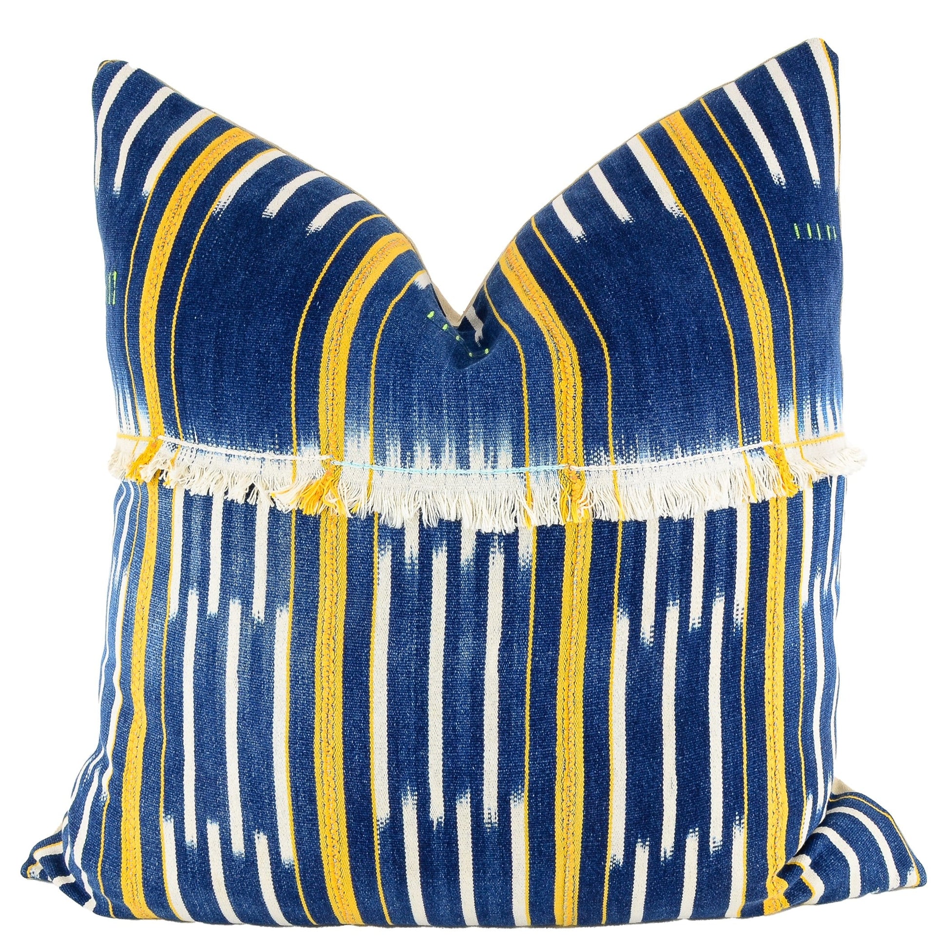 Front of pillow with rich blue and white patterns, yellow stripes and white fringe made from vintage handwoven Baoulé/Baule cotton cloth from Africa's Ivory Coast, reflecting the traditions, symbols, and tribal lives of the Baoulé/Baule people