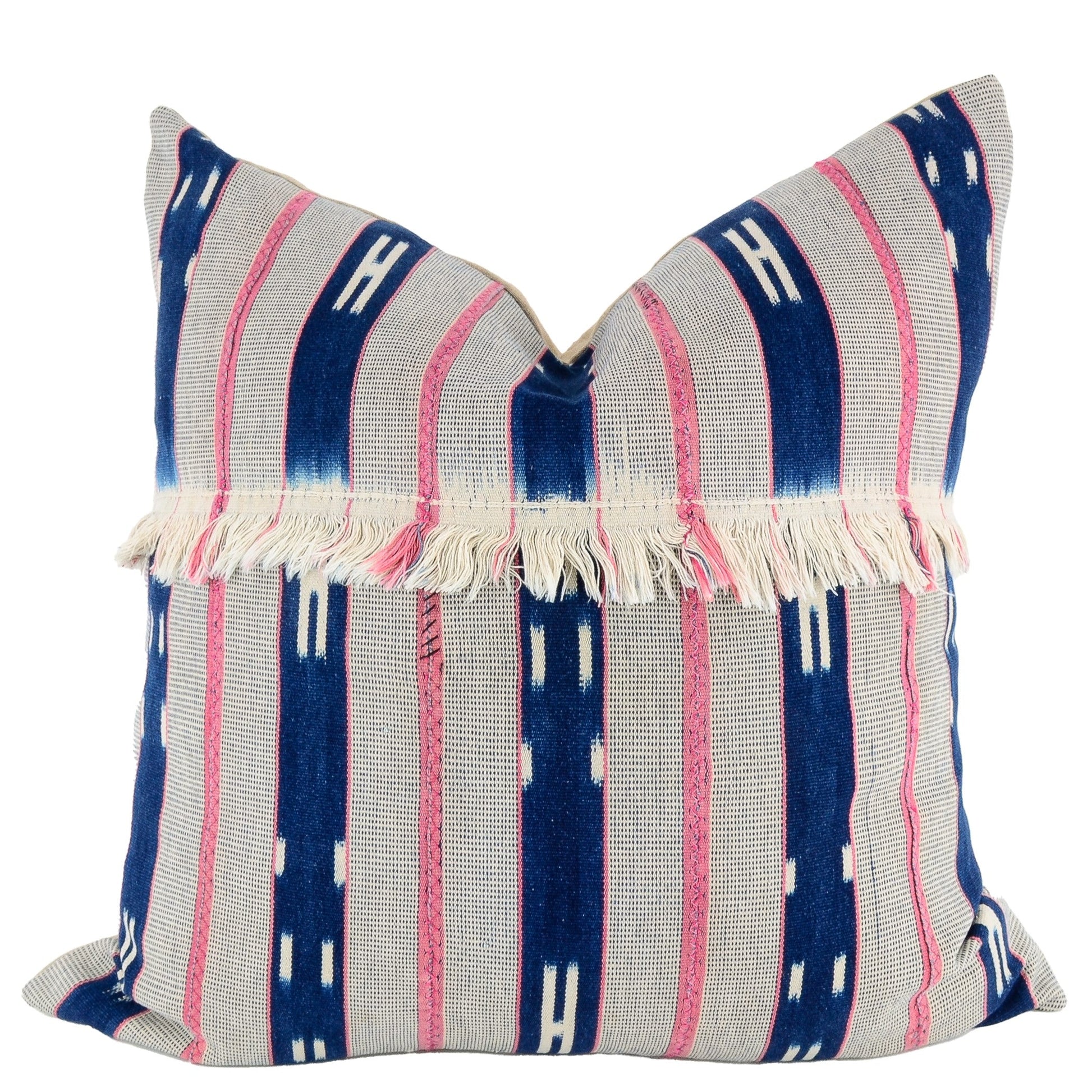 Front of pillow with rich blue and white patterns, gray and pink stripes and white fringe made from vintage handwoven Baoulé/Baule cotton cloth from Africa's Ivory Coast, reflecting the traditions, symbols, and tribal lives of the Baoulé/Baule people