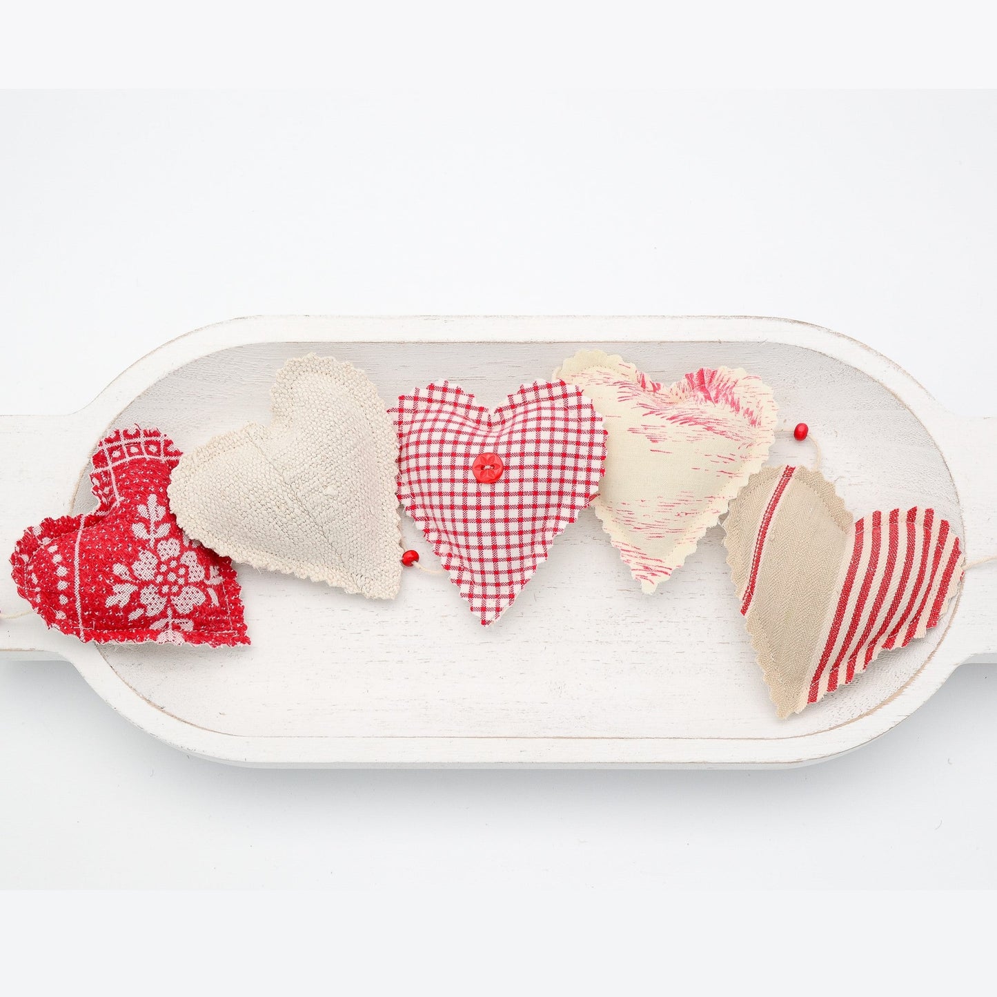 Focus on two hearts in this vintage French fabric garland, white cotton twine and wooden beads between hearts