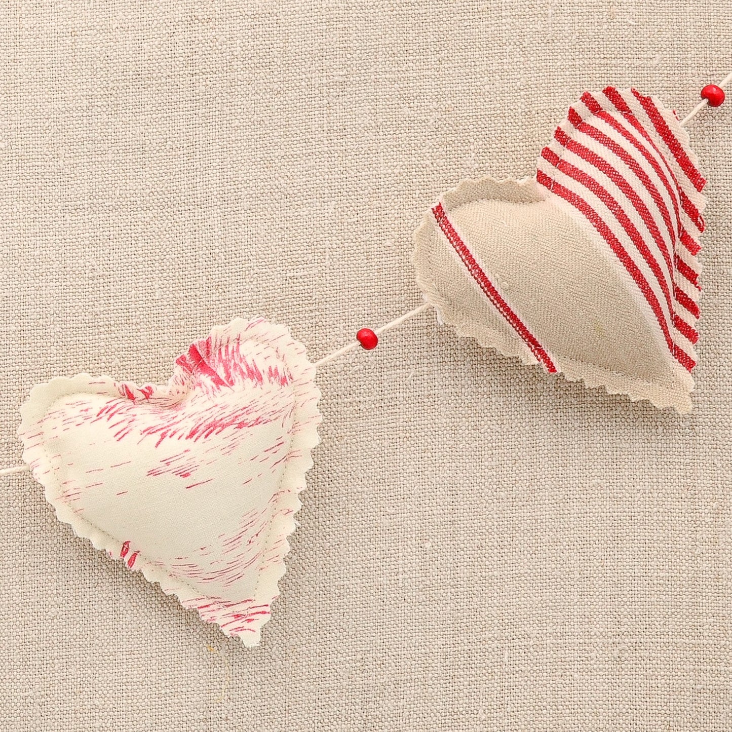 Vintage French fabric garland, five colorful hearts, white cotton twine and wooden beads between hearts
