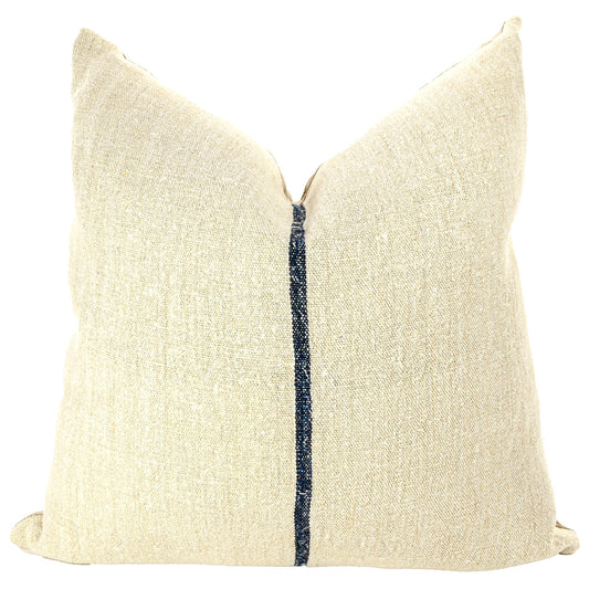 Front of pillow made from antique European grain sack natural tone linen with a deep indigo vertical stripe in the middle of the pillow