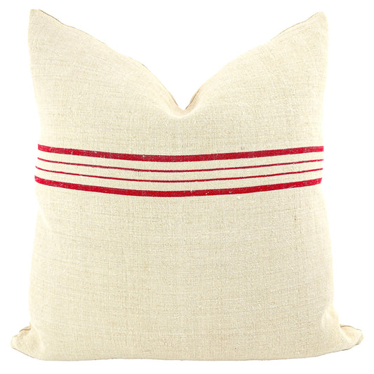 Front of pillow made from antique European grain sack natural tone linen with red horizontal stripes in the upper middle of the pillow