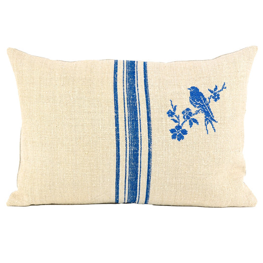 Front of pillow made from antique European grain sack natural tone linen with rich blue stripes that are perfectly complemented by a blue cross-stitched bird, embroidered using an old French pattern