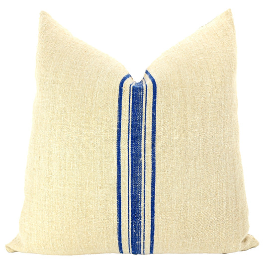 Front of pillow made from antique European grain sack natural tone linen with rich blue vertical stripes in the middle of the pillow
