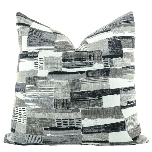 Front of pillow made from a contemporary/modern fabric with rich black, gray and white patterns