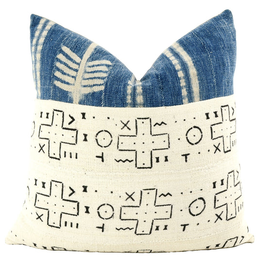 Front of pillow with rich white and black patterns made from a traditional handwoven mudcloth textile sheet and accented at the top with rich blue and white patterns made from vintage indigo cotton cloth, both textiles fromfrom Mali West Africa