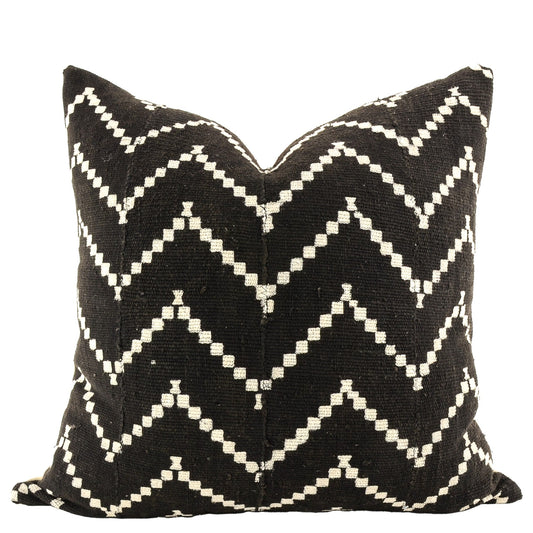 Front of pillow with rich black and white patterns made from a traditional handwoven mudcloth textile sheet from Mali West Africa