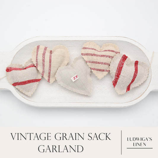 Vintage European grain sack linen garland, white cotton twine and wooden beads between hearts