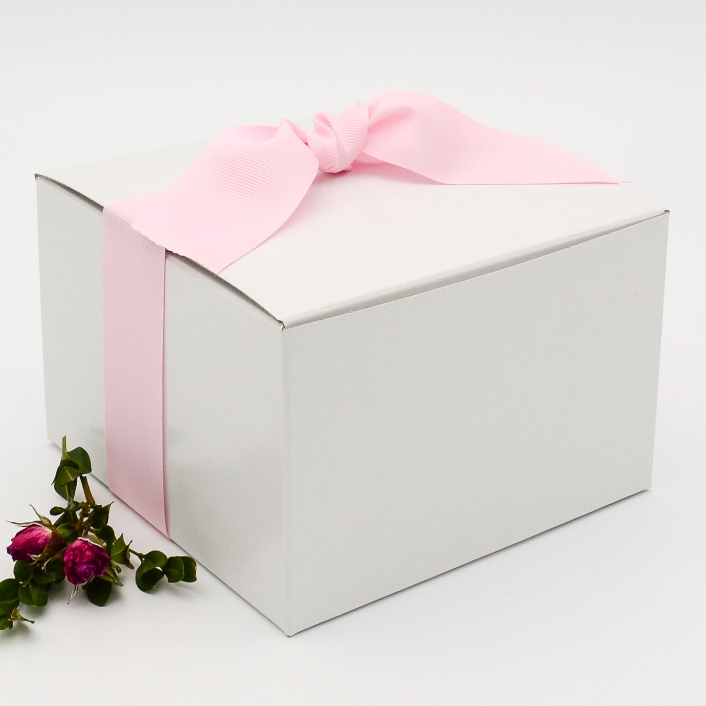 White gift box with pink grosgrain ribbon