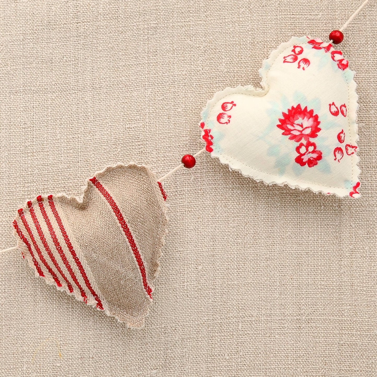 Vintage French fabric garland, five colorful hearts, white cotton twine and wooden beads between hearts