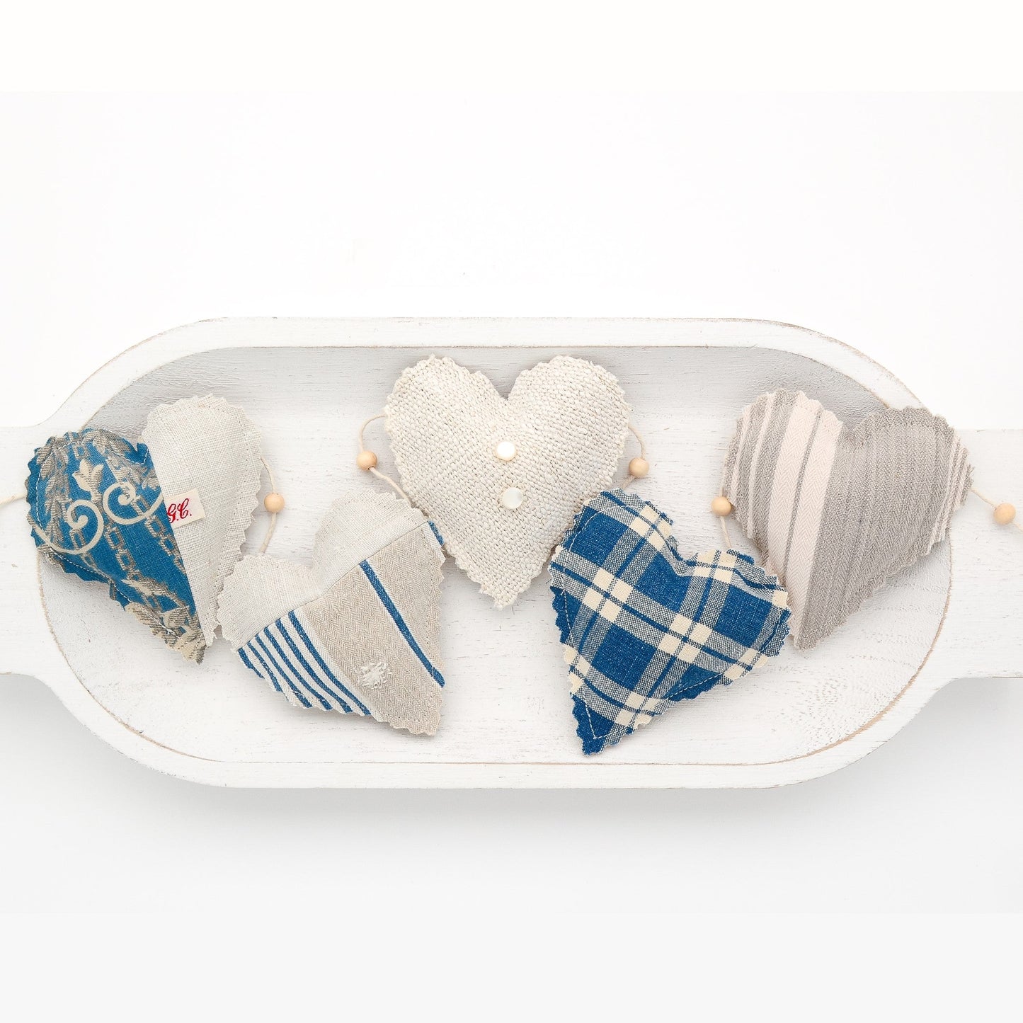 Focus on two hearts in this vintage French fabric garland, white cotton twine and wooden beads between hearts