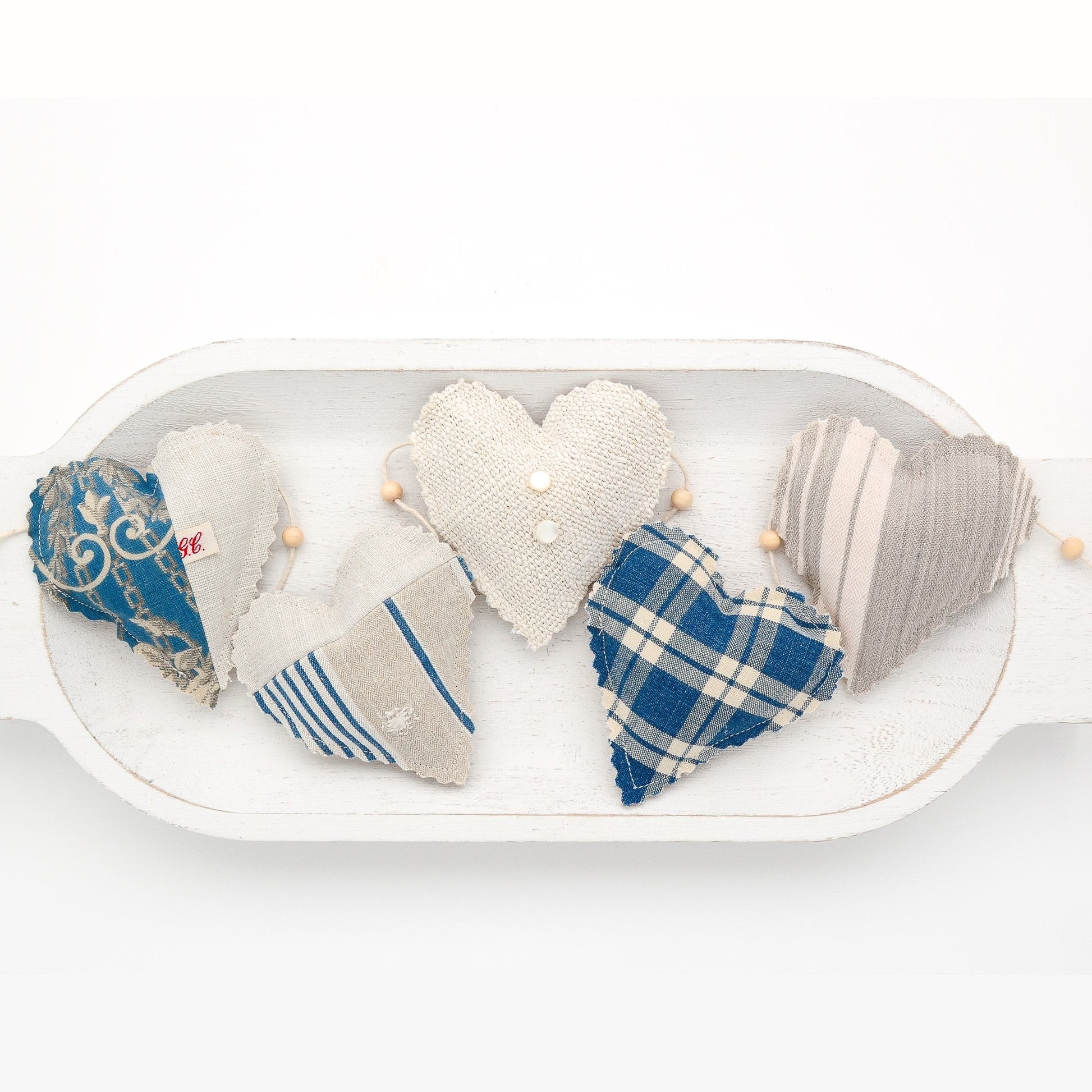 Focus on two hearts in this vintage French fabric garland, white cotton twine and wooden beads between hearts