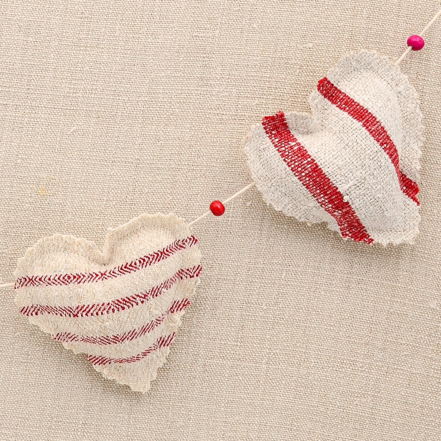 Vintage European grain sack linen garland, five hearts, white cotton twine and wooden beads between hearts