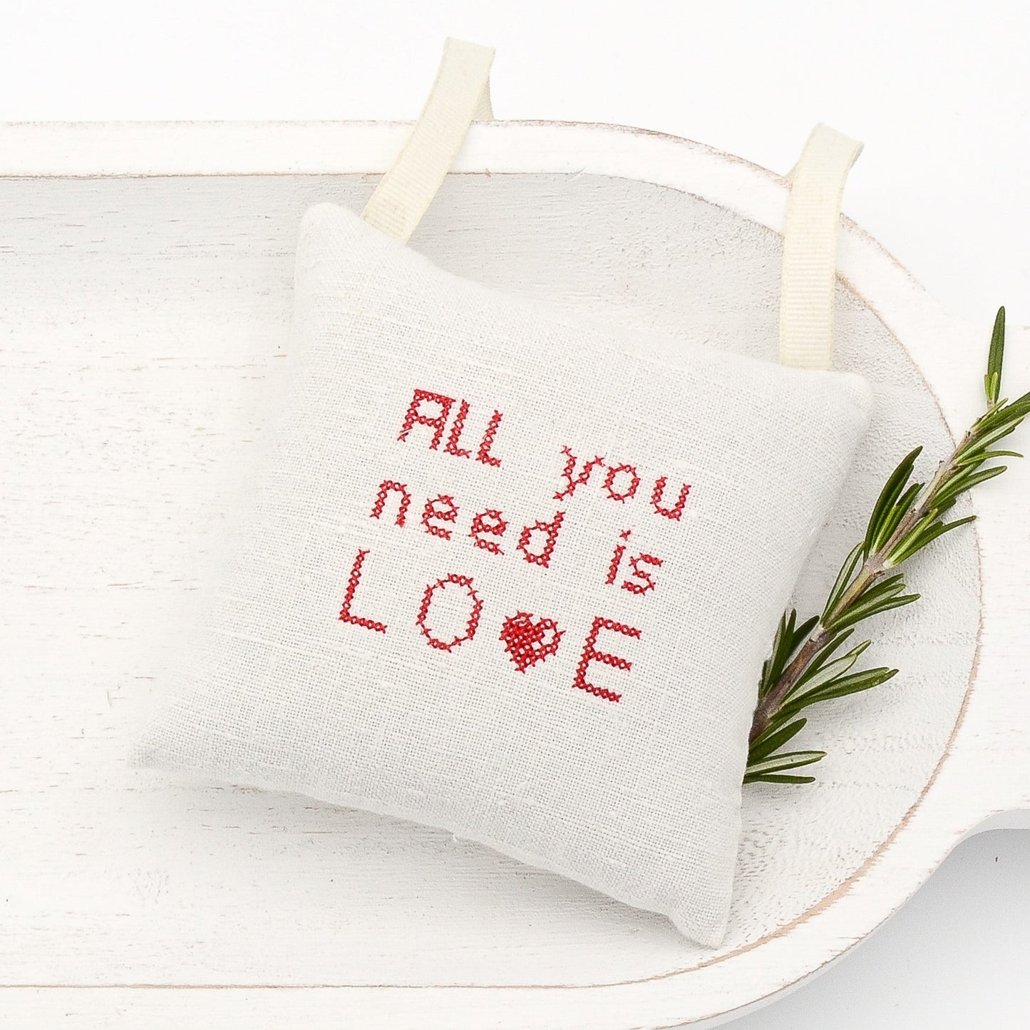 Antique European white linen lavender sachet square, "All you need is love" embroidered in red cross stitch, cream-colored gros grain ribbon tie, filled with high quality lavender from Provence France