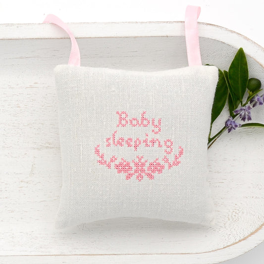 Antique European white linen lavender sachet square, "Baby sleeping" and garland embroidered in pink cross stitch, pink satin ribbon tie, filled with high quality lavender from Provence France