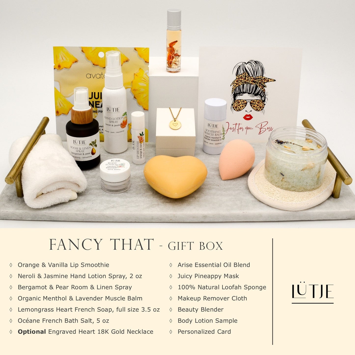 Fancy That Gift Box for women, BFF, wife, daughter, sister, mom, or grandma, includes Neroli & Jasmine hand lotion spray, essential oil, lip balm, soothing muscle balm, Bergamot & Pear room & linen spray, French soap, French bath salts, hydrating face mask, other bath, spa and self-care items, and optional 18K gold-plated necklace with engraved heart.