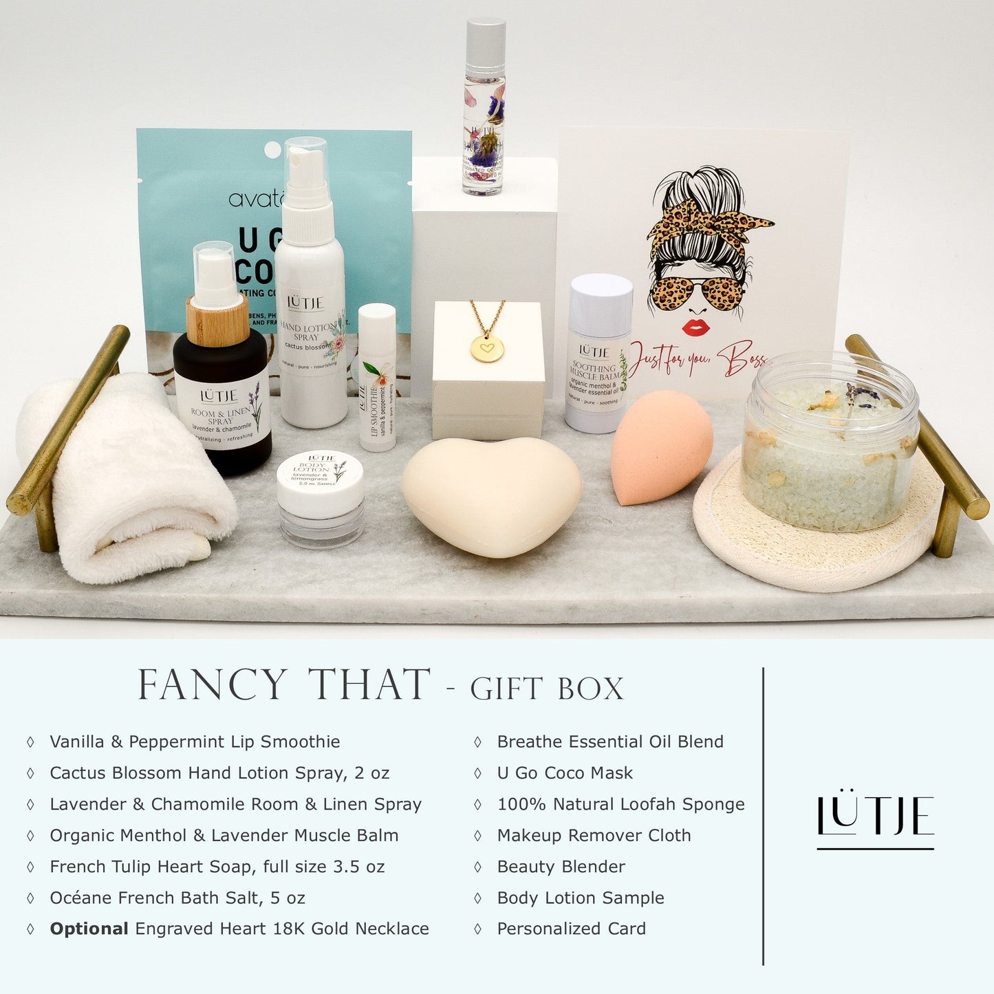 Fancy That Gift Box for women, BFF, wife, daughter, sister, mom, or grandma, includes Cactus Blossom hand lotion spray, essential oil, lip balm, soothing muscle balm, Lavender & Chamomile room & linen spray, French soap, French bath salts, hydrating face mask, other bath, spa and self-care items, and 18K gold-plated necklace with engraved heart.