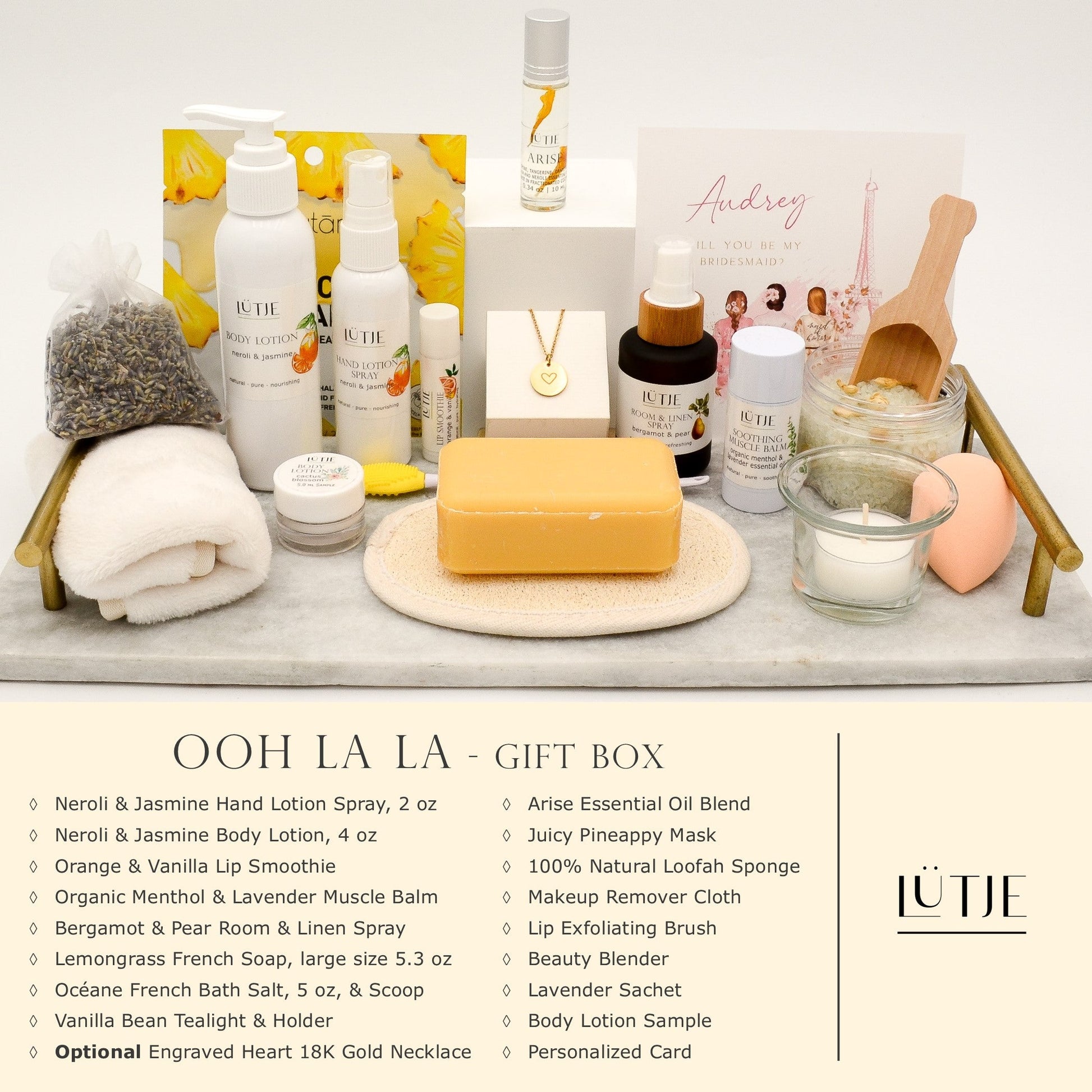Ooh La La Gift Box for women, wife, daughter, BFF, sister, mom, or grandma, includes Neroli & Jasmine hand lotion spray and body lotion, essential oil, lip balm, soothing muscle balm, Bergamot & Pear room & linen spray, French soap, French bath salts, hydrating face mask, other bath, spa and self-care items, and optional 18K gold-plated necklace with engraved heart.