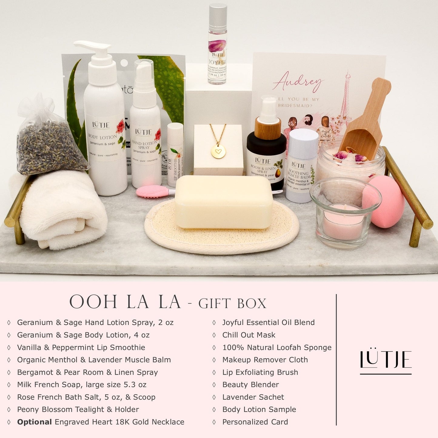 Ooh La La Gift Box for women, wife, daughter, BFF, sister, mom, or grandma, includes Geranium & Sage hand lotion spray and body lotion, essential oil, lip balm, soothing muscle balm, Bergamot & Pear room & linen spray, French soap, French bath salts, hydrating face mask, other bath, spa and self-care items, and 18K gold-plated necklace with engraved heart.