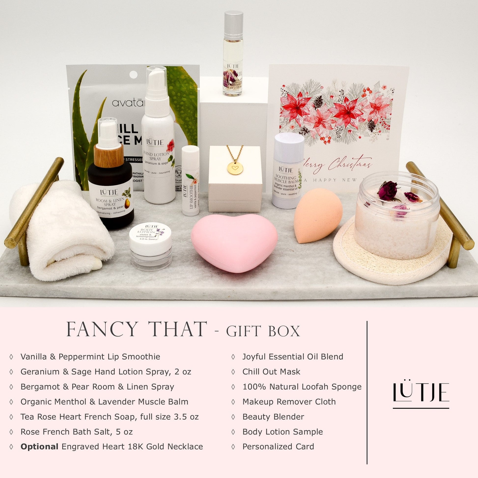 Fancy That Gift Box for women, BFF, wife, daughter, sister, mom, or grandma, includes Geranium & Sage hand lotion spray, essential oil, lip balm, soothing muscle balm, Bergamot & Pear room & linen spray, French soap, French bath salts, hydrating face mask, other bath, spa and self-care items, and 18K gold-plated necklace with engraved heart.