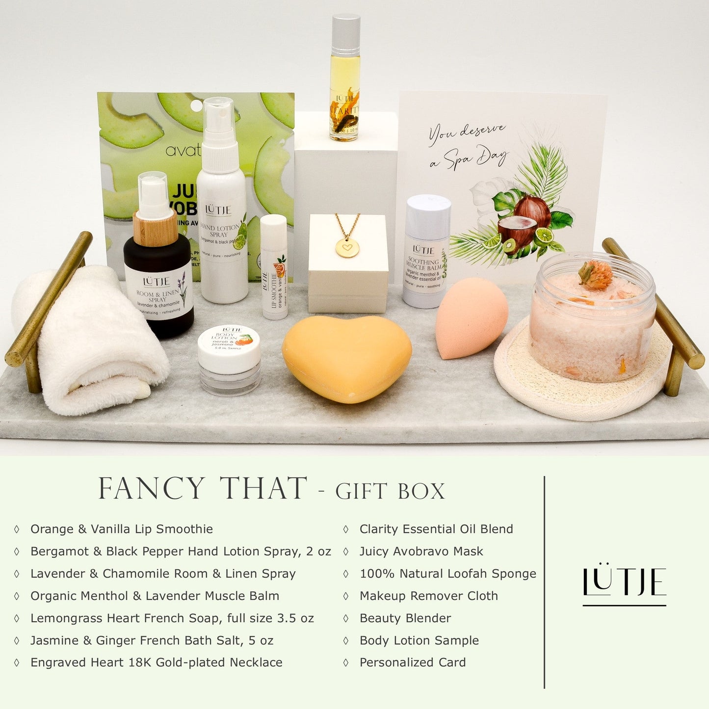 Fancy That Gift Box for women, BFF, wife, daughter, sister, mom, or grandma, includes Bergamot & Black Pepper hand lotion spray, essential oil, lip balm, soothing muscle balm, Lavender & Chamomile room & linen spray, French soap, French bath salts, hydrating face mask, other bath, spa and self-care items, and optional 18K gold-plated necklace with engraved heart.