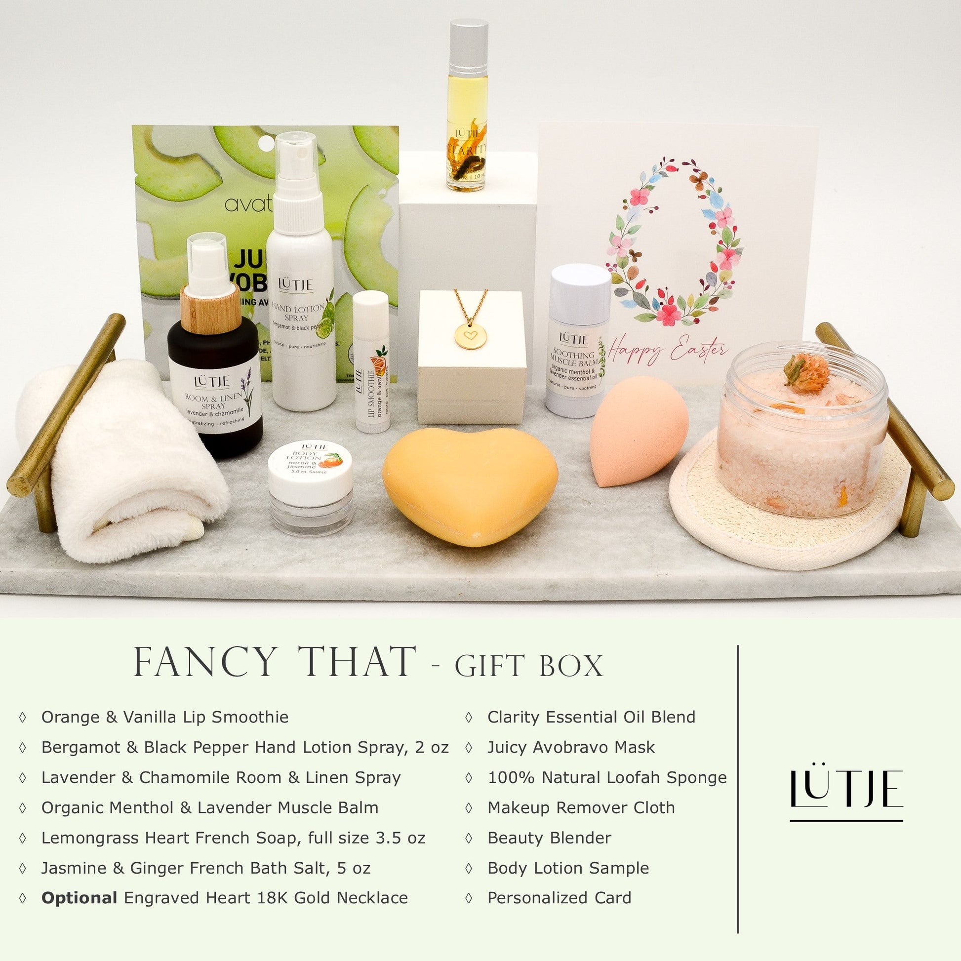 Fancy That Gift Box for women, BFF, wife, daughter, sister, mom, or grandma, includes Bergamot & Black Pepper hand lotion spray, essential oil, lip balm, soothing muscle balm, Lavender & Chamomile room & linen spray, French soap, French bath salts, hydrating face mask, other bath, spa and self-care items, and optional 18K gold-plated necklace with engraved heart.