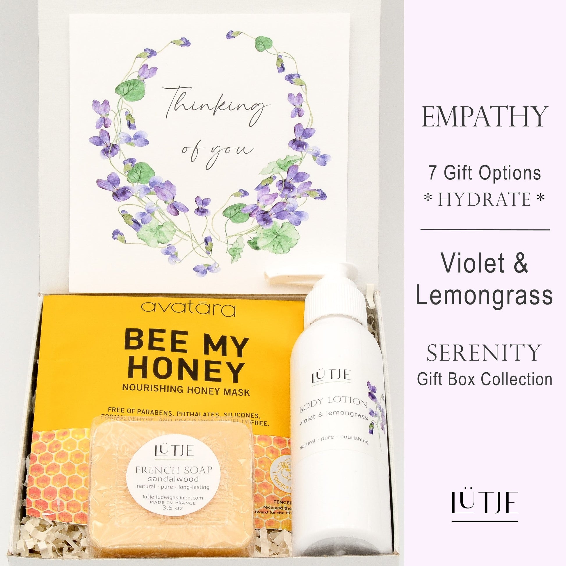 Gift Box for women, wife, daughter, BFF, sister, mom, or grandma, includes Violet & Lemongrass hand lotion spray and body lotion, essential oil, lip balm, soothing muscle balm, Bergamot & Pear room & linen spray, French soap, French bath salts, hydrating face mask, other bath, spa and self-care items, and 18K gold-plated necklace with engraved heart.