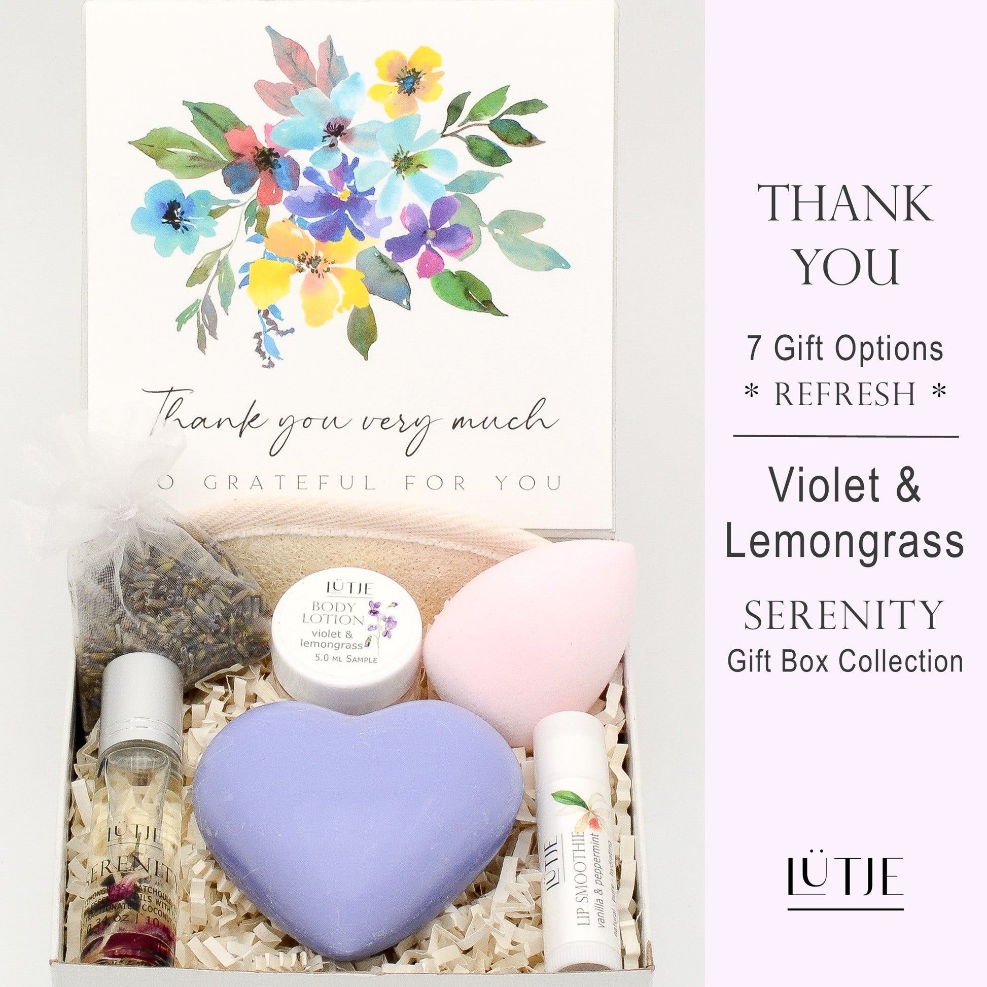Gift Box for women, wife, daughter, BFF, sister, mom, or grandma, includes Violet & Lemongrass hand lotion spray and body lotion, essential oil, lip balm, soothing muscle balm, Bergamot & Pear room & linen spray, French soap, French bath salts, hydrating face mask, other bath, spa and self-care items, and 18K gold-plated necklace with engraved heart.