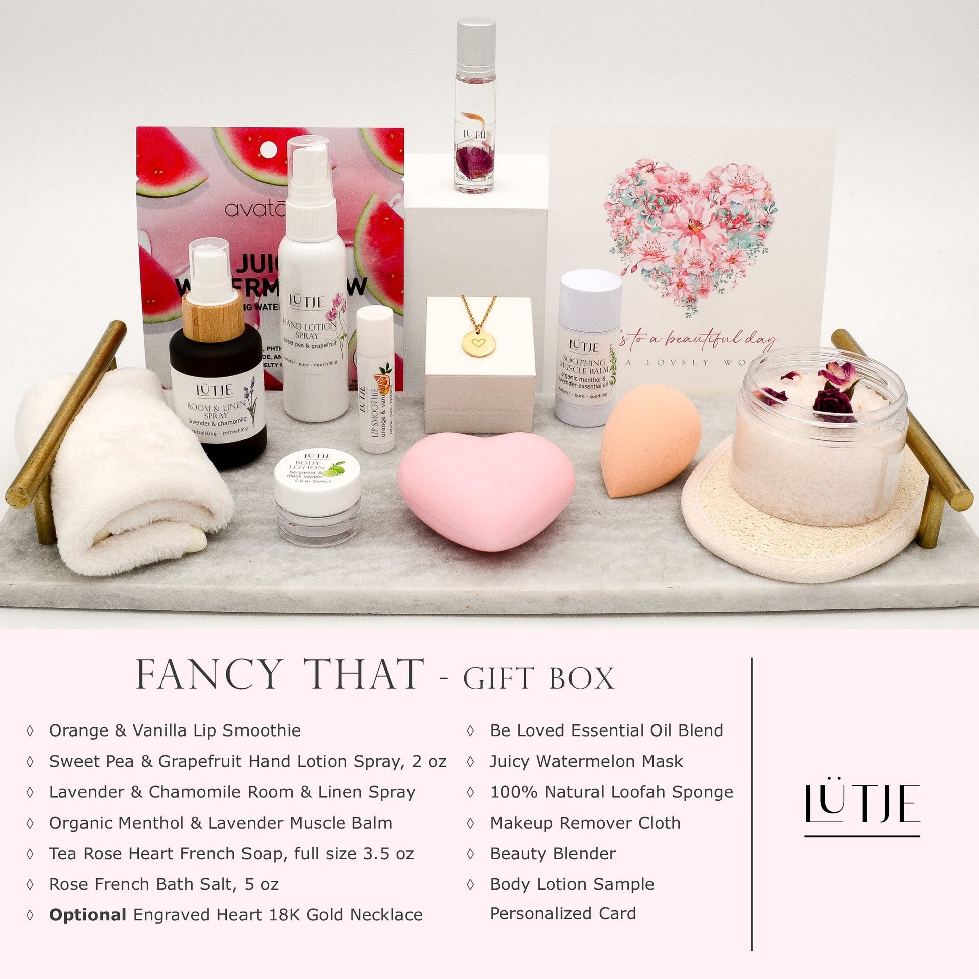 Fancy That Gift Box for women, BFF, wife, daughter, sister, mom, or grandma, includes Sweet Pea & Grapefruit hand lotion spray, essential oil, lip balm, soothing muscle balm, Lavender & Chamomile room & linen spray, French soap, French bath salts, hydrating face mask, other bath, spa and self-care items, and 18K gold-plated necklace with engraved heart.